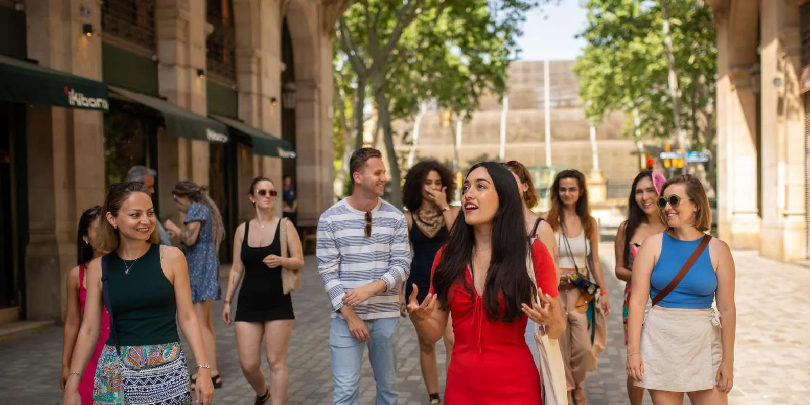 A guide leading a small-group walking tour through the arcaded streets of Barcelona's Gothic Quarter
